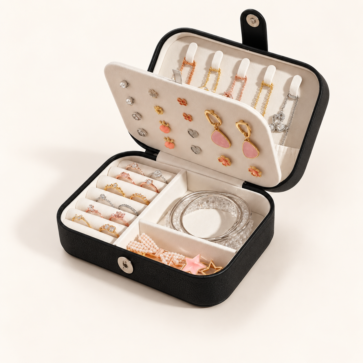 Black jewellery organiser open to reveal ring rolls, necklace hooks and an ivory interior